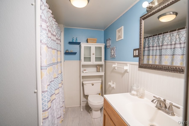 bathroom featuring toilet, vanity, crown molding, tile patterned floors, and a shower with shower curtain