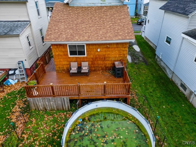 back of house with a wooden deck and a yard