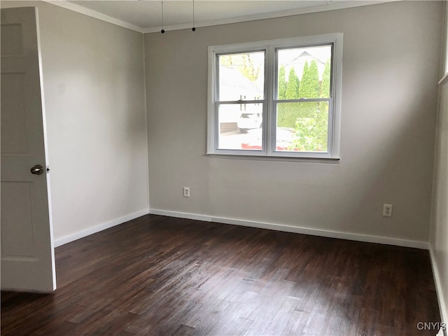 unfurnished room with dark wood-type flooring and ornamental molding