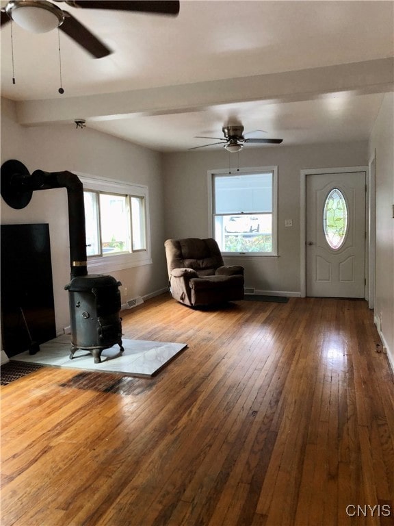 foyer entrance featuring wood-type flooring, a healthy amount of sunlight, and ceiling fan