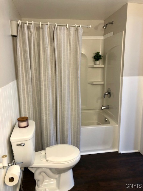 bathroom featuring toilet, shower / bath combo, and wood-type flooring