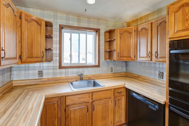 kitchen featuring butcher block countertops, black appliances, sink, and tasteful backsplash