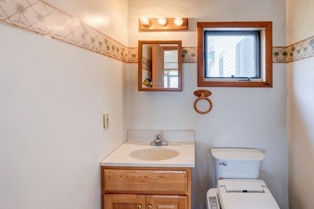 bathroom featuring toilet and vanity