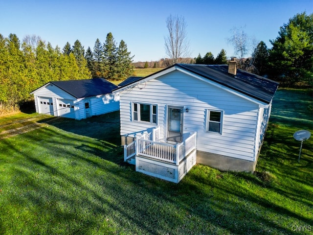 rear view of house featuring a lawn