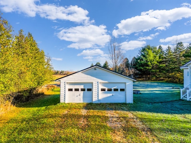 garage featuring a yard