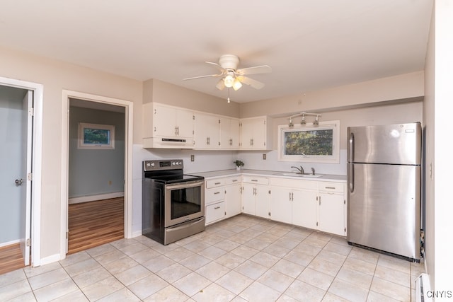 kitchen with light hardwood / wood-style flooring, sink, white cabinetry, appliances with stainless steel finishes, and ceiling fan