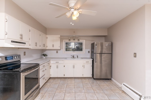 kitchen with sink, a baseboard radiator, stainless steel appliances, white cabinets, and light tile patterned floors