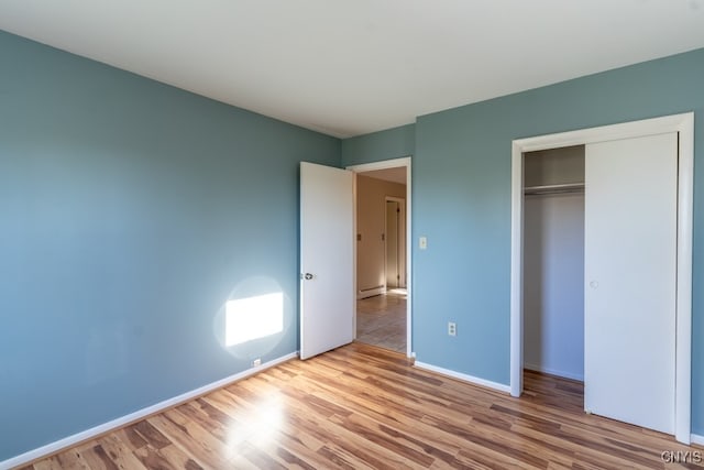 unfurnished bedroom featuring a closet and light wood-type flooring