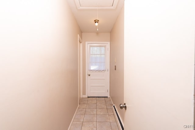 doorway featuring a baseboard heating unit and light tile patterned floors