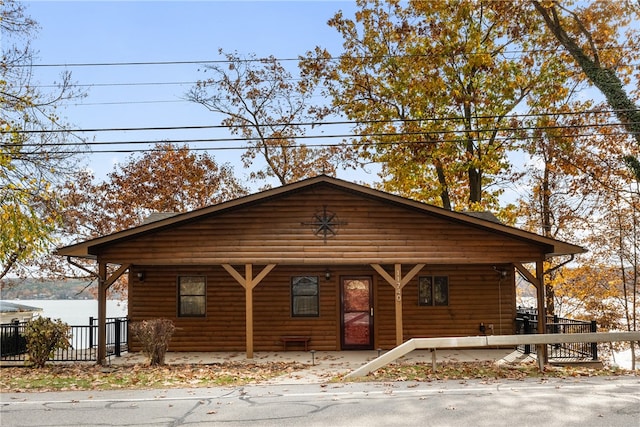 log home featuring covered porch