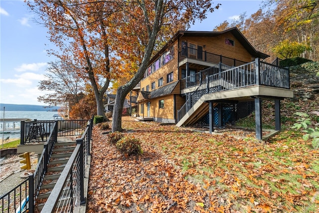 back of house with a deck with water view