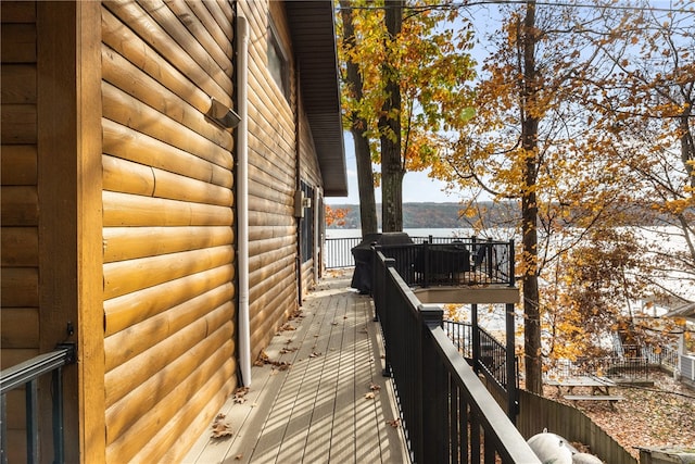 view of side of home featuring a deck with water view