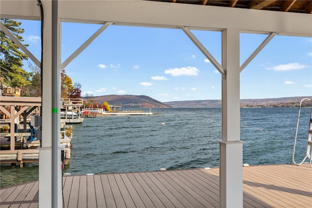 view of dock with a water and mountain view