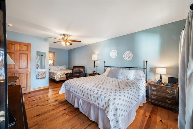 bedroom with wood-type flooring and ceiling fan