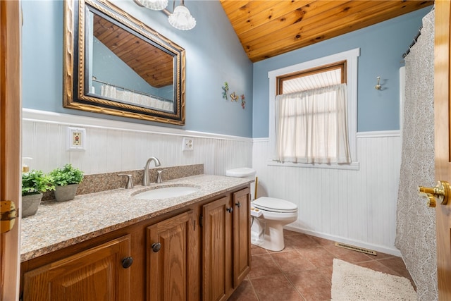 bathroom featuring toilet, wooden ceiling, vaulted ceiling, vanity, and tile patterned flooring