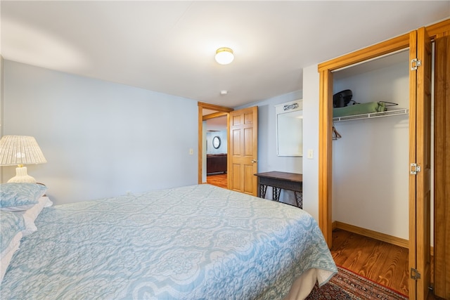 bedroom featuring a closet, a walk in closet, and hardwood / wood-style floors