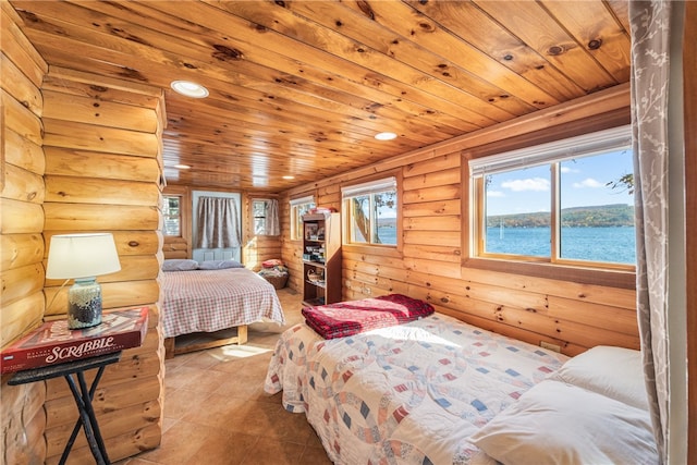 tiled bedroom featuring wooden ceiling and a water view