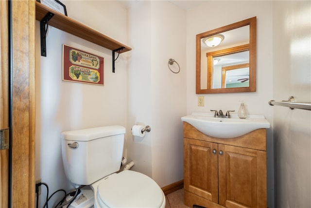 bathroom featuring vanity, toilet, and tile patterned flooring