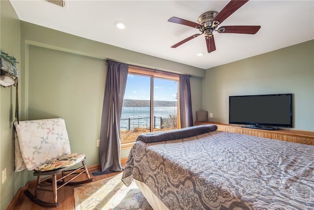 bedroom with ceiling fan and hardwood / wood-style flooring