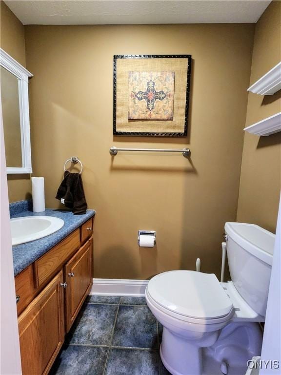 bathroom with tile patterned floors, vanity, and toilet