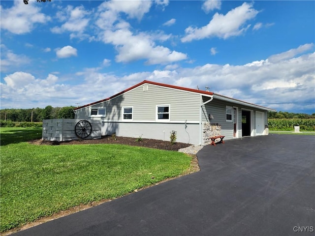 view of front of home with a front yard and a garage