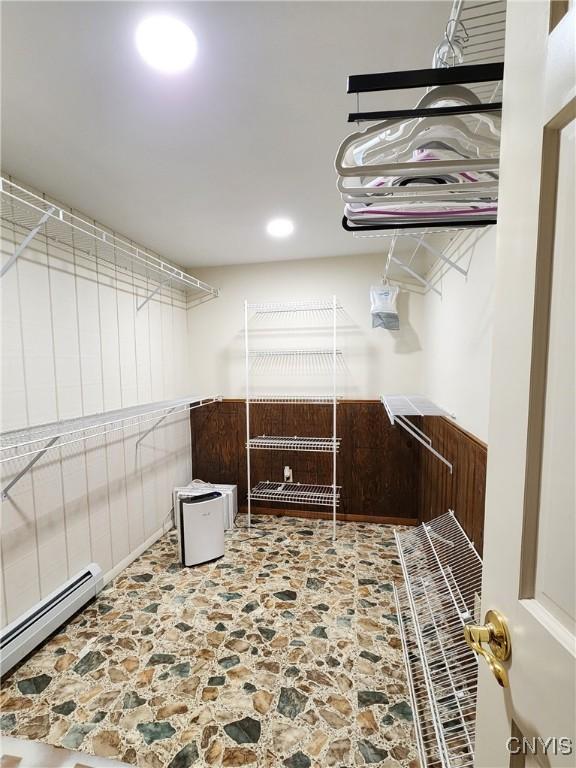 spacious closet featuring a baseboard heating unit