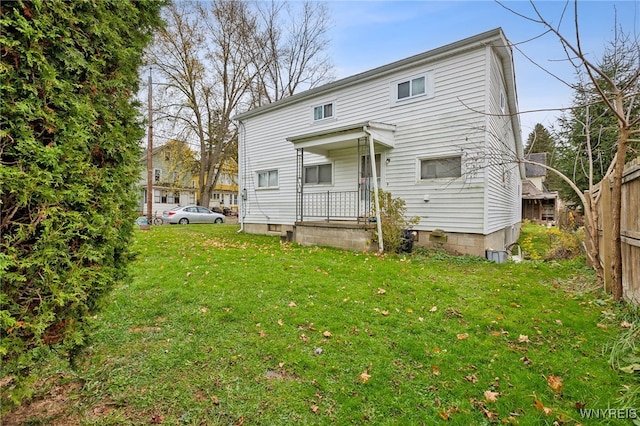 back of house featuring a yard