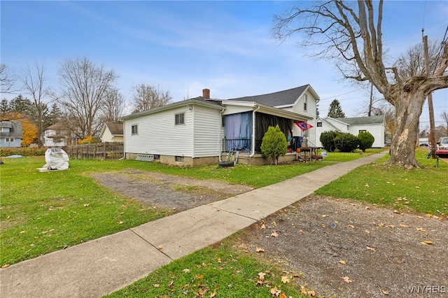 view of side of home featuring a lawn