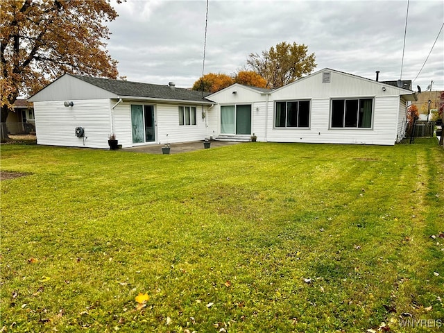 back of house with a lawn