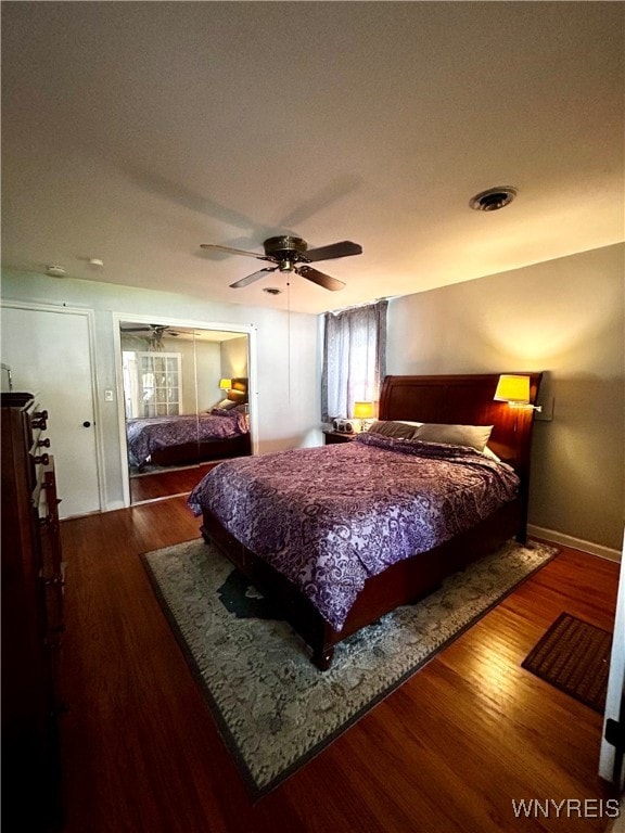 bedroom featuring hardwood / wood-style floors, ceiling fan, and a closet