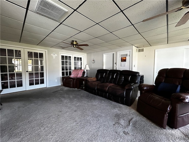 living room featuring ceiling fan, a paneled ceiling, carpet flooring, and french doors