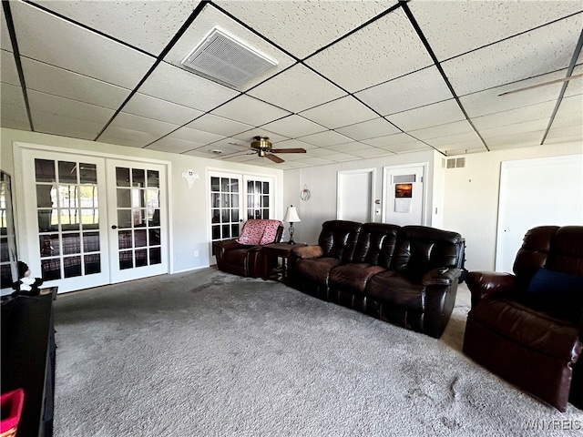 living room featuring a paneled ceiling, french doors, carpet flooring, and ceiling fan