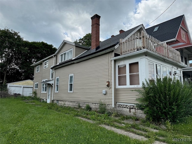 rear view of house featuring a yard