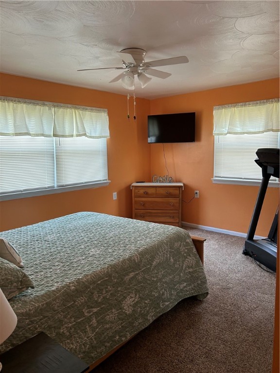 carpeted bedroom featuring ceiling fan