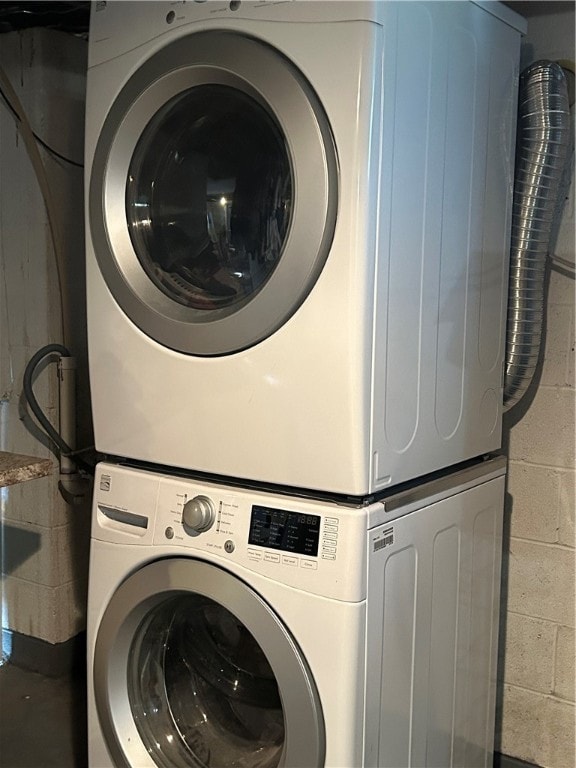 laundry area with stacked washer and dryer