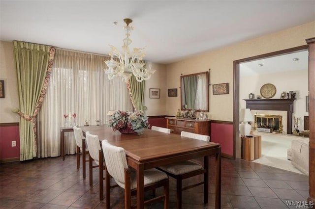 tiled dining area featuring a chandelier