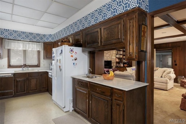 kitchen with stainless steel dishwasher, sink, dark brown cabinets, and a paneled ceiling