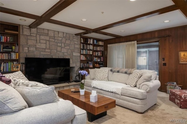 carpeted living room featuring wood walls, beamed ceiling, and coffered ceiling