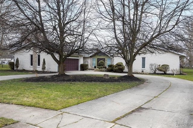 view of front of property with a front yard and a garage