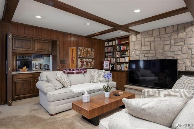 carpeted living room featuring beamed ceiling, wooden walls, and coffered ceiling