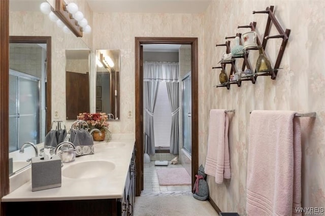 bathroom featuring a shower with door and vanity