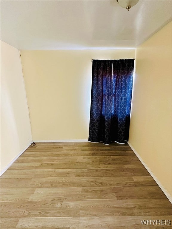 unfurnished room featuring hardwood / wood-style floors