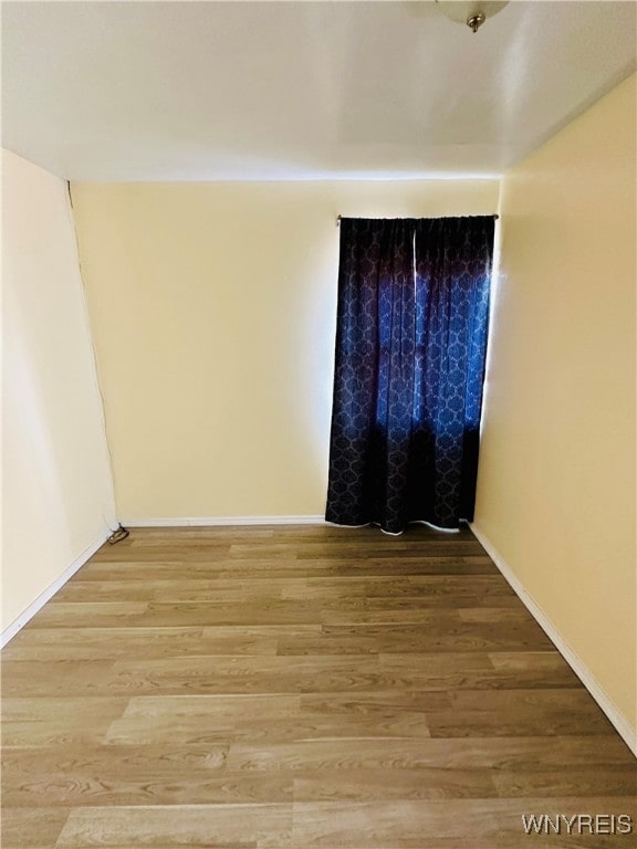 empty room with wood-type flooring