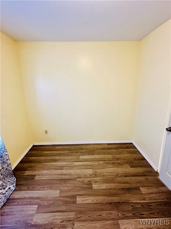 unfurnished room with dark hardwood / wood-style floors