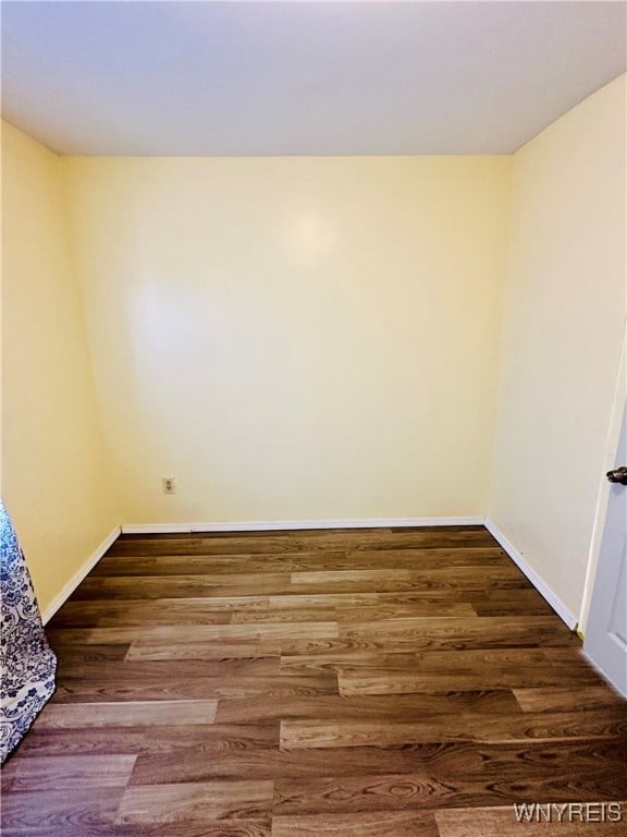 empty room featuring dark wood-type flooring