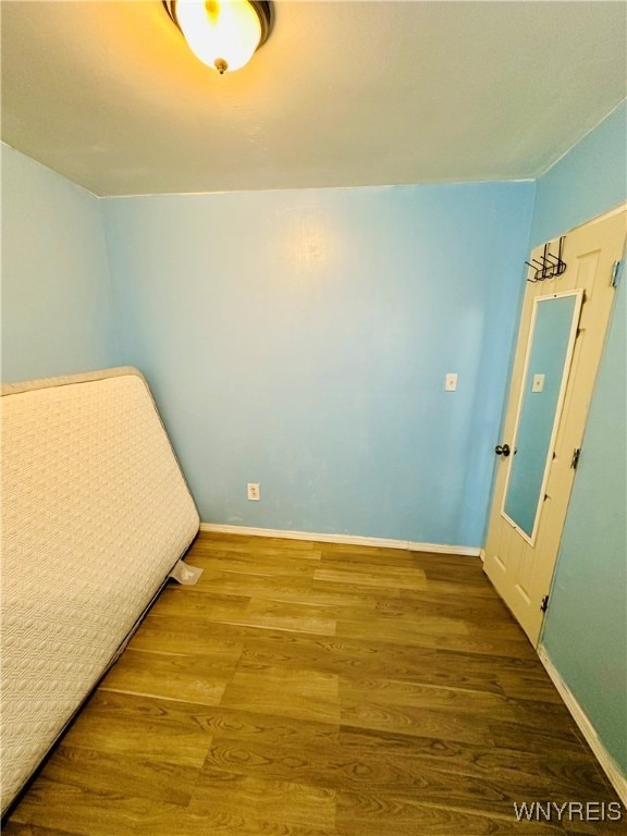 unfurnished bedroom featuring hardwood / wood-style flooring