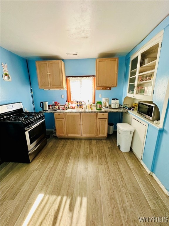 kitchen with gas stove and light wood-type flooring