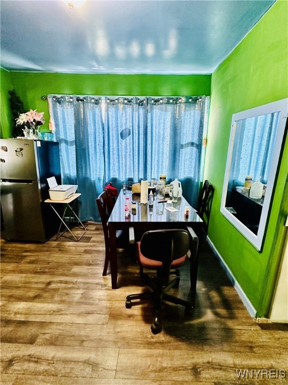 dining space with hardwood / wood-style flooring