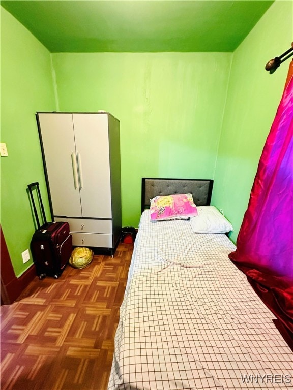 bedroom with dark parquet floors