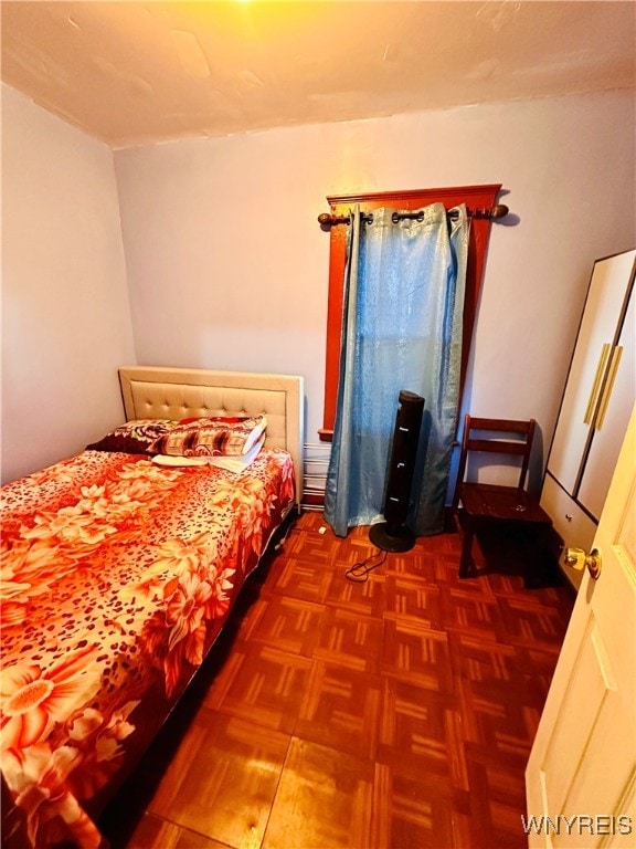 bedroom with dark parquet floors